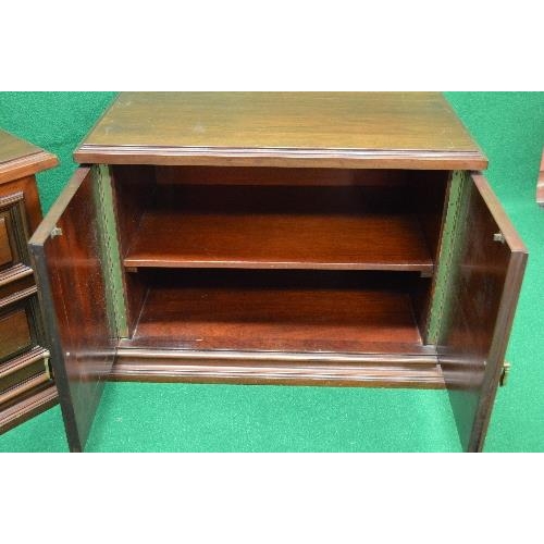 65 - Pair of mahogany side cabinets the tops having moulded edges over two cupboard doors with brass hand... 