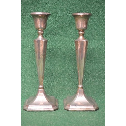 505 - Pair of silver candlesticks having weighted bases with fluted sconces supported on inward tapering s... 