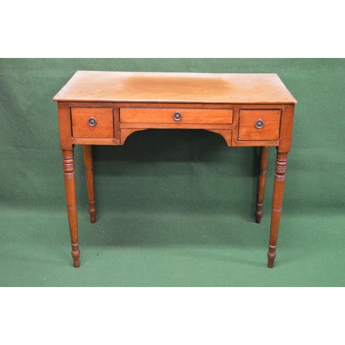 136 - 19th century mahogany side table having central drawer flanked by small drawers, standing on turned ... 