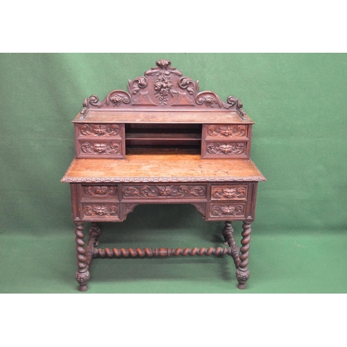 21 - Oak carved writing desk having raised back fitted with drawers and shelf over a series of drawers, s... 