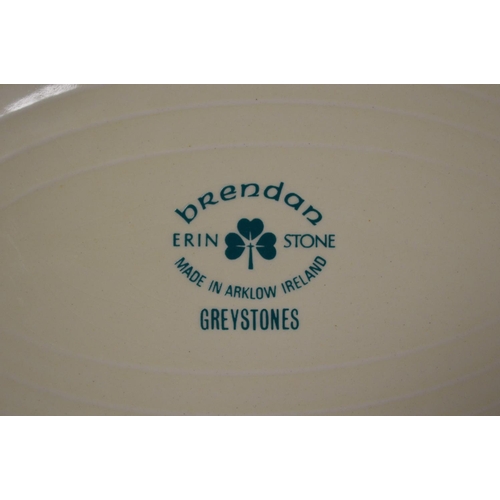 255 - Brendan Erin Stone, Greystones pattern tea and dinner service having a green/yellow ground with flor... 