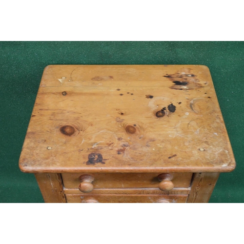 30 - Pine side table having rectangular top over two short drawers with knob handles, standing on square ... 