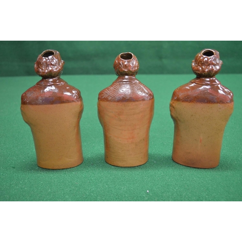 343 - Group of three Doulton earthenware flasks in the form of figures - 7.25