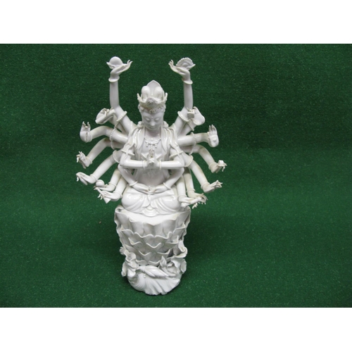 358 - Blanc de Chine figure of Guanyin with eighteen arms, some hands holding attributes and seated with c... 