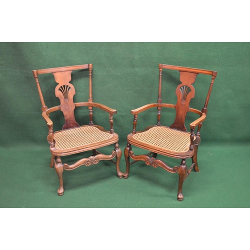 42 - Pair of open elbow chairs having pierced back splat over a cane work seat, standing on stretchered c... 