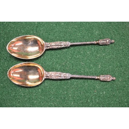 459 - Pair of silver salts having blue glass liners, marked for London together with a pair of silver gilt... 