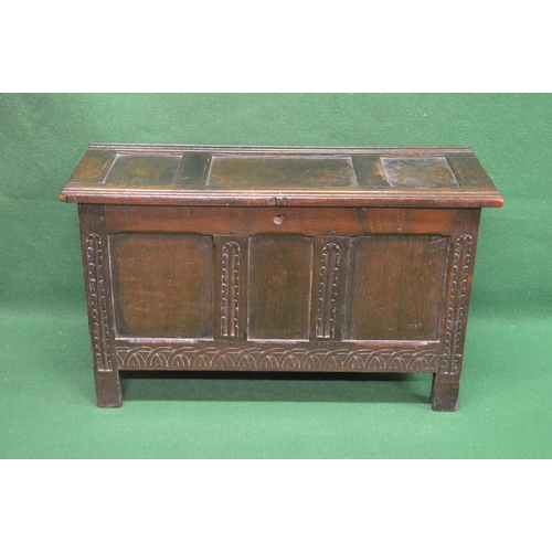 49 - Oak carved three panel coffer the top opening to reveal storage space, standing on stile feet - 37.7... 