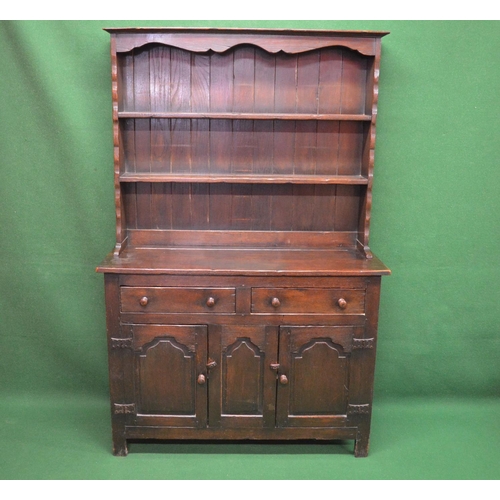 91 - Oak dresser the top having shaped frieze over two fixed shelves the base having two drawers over two... 