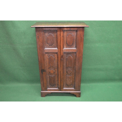 95 - Oak side cabinet having two panelled doors each door having two panels opening to reveal three fixed... 