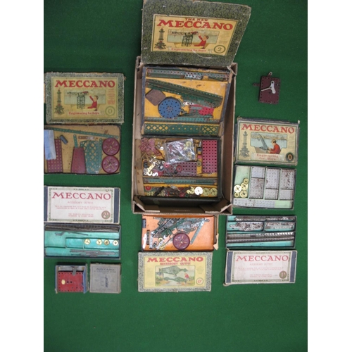 216 - Seven pre-war Meccano boxes, with some contents, together with two clockwork motors with keys (one b... 