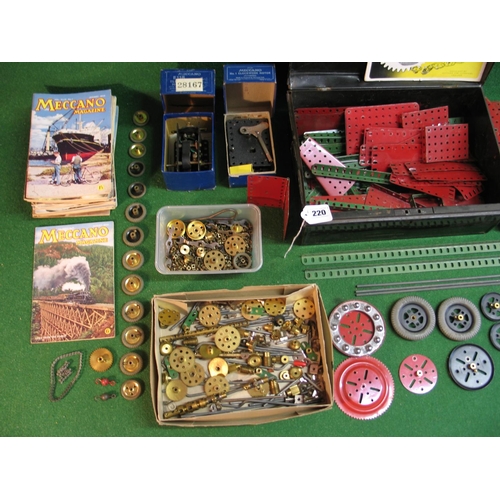 220 - Loft find Meccano collection of red and green parts, boxed clockwork and electric motors, wheels, ge... 