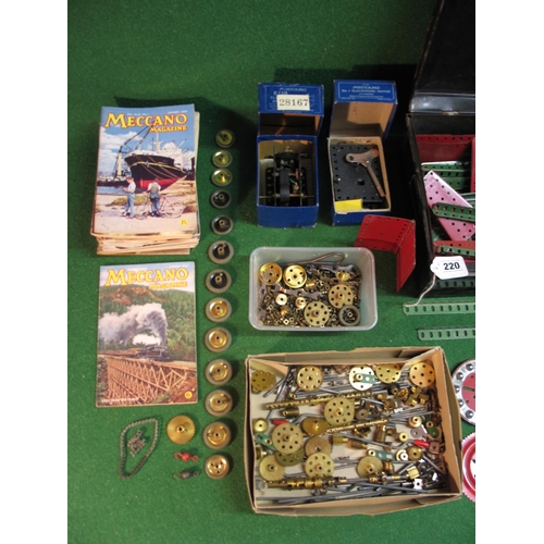 220 - Loft find Meccano collection of red and green parts, boxed clockwork and electric motors, wheels, ge... 