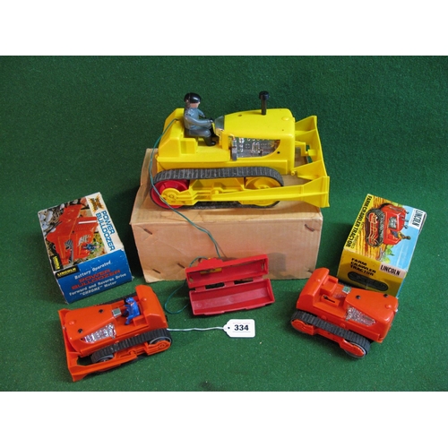 334 - Three plastic battery operated crawlers to comprise: Power bulldozer and farm crawler tractor, both ... 