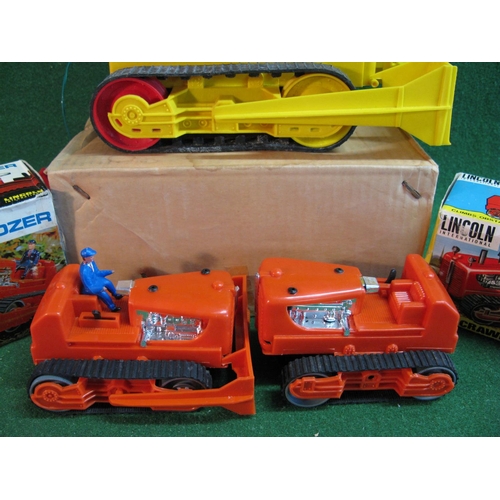 334 - Three plastic battery operated crawlers to comprise: Power bulldozer and farm crawler tractor, both ... 