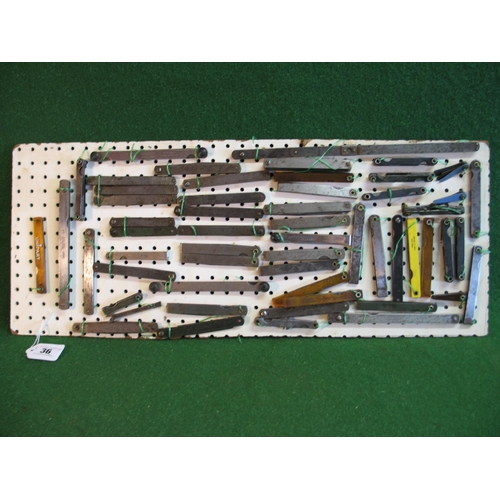 36 - Collection of fifty six feeler gauges mounted onto pegboard