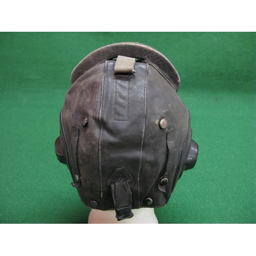 243 - Leather flying helmet with alloy buckles and clips, built in speaker and a curved sponge buffer on t... 