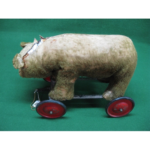 266 - 80 year old possibly Chad Valley wheeled bear with solid wheels and steering, well loved but now nee... 