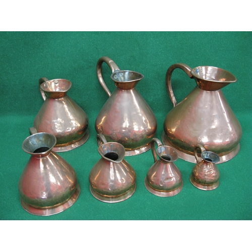 267 - Seven Victorian graduated copper jugs to comprise: four gallon, three gallon, two gallon, one gallon... 