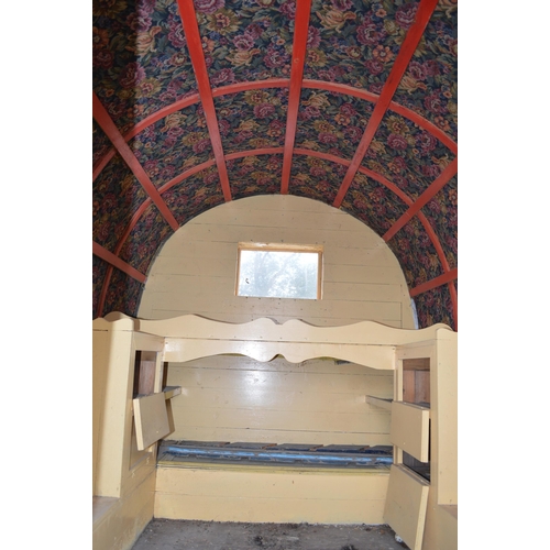 299 - Bow top gypsy caravan with green canvas roof, ornate floral tapestry to underside of roof, currently... 