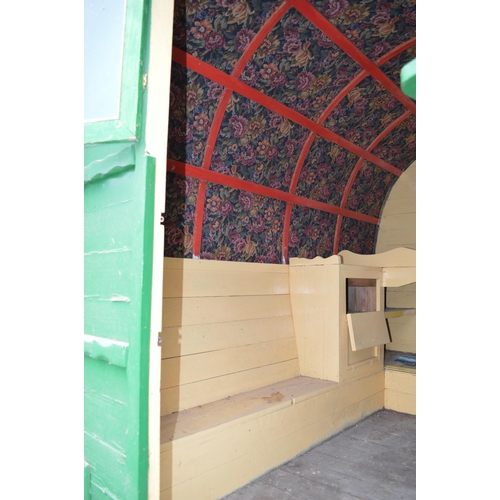 299 - Bow top gypsy caravan with green canvas roof, ornate floral tapestry to underside of roof, currently... 