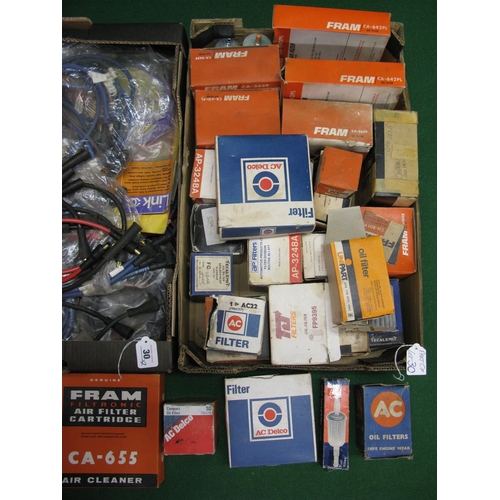 30 - Two boxes of assorted new old stock filters and spark plug leads