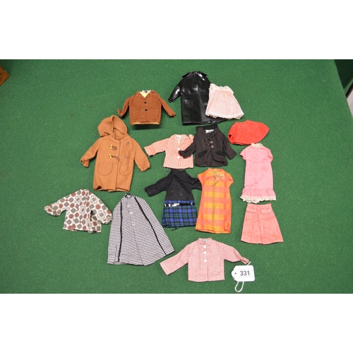 331 - Two dolls with bespoke wooden wardrobe, Sindy set booklet with selection of Sindy clothes, other clo... 