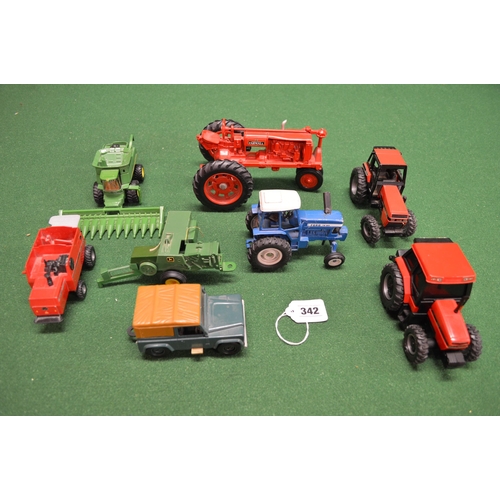 342 - Two boxes of diecast and plastic tractors and implements made by Ertl to include a vintage Farmall F... 