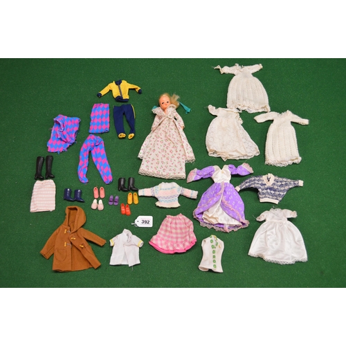 392 - Sindy doll with four bags of clothes to include: equestrian and a bag of shoes