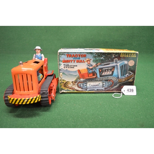 439 - Battery operated tinplate Mighty Bull caterpillar tractor with vibrating engine and driver made in J... 