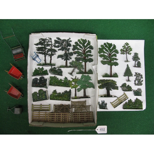 452 - Tray of diecast trees, hedging, flowering shrubs, fencing, two wheelbarrows, sack barrow, garden rol... 