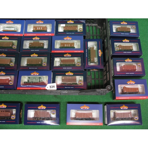 534 - Twenty boxed unused Bachmann OO four wheel open and covered wagons, guards vans, tanker, cattle truc... 