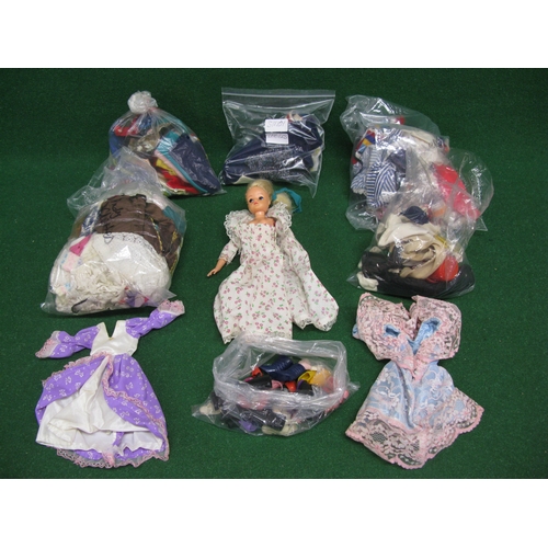 392 - Sindy doll with four bags of clothes to include: equestrian and a bag of shoes