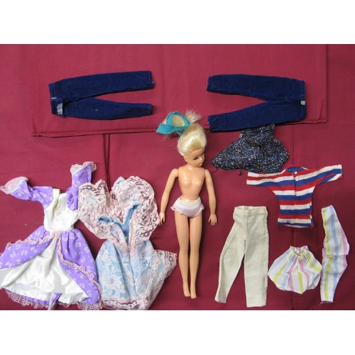 392 - Sindy doll with four bags of clothes to include: equestrian and a bag of shoes