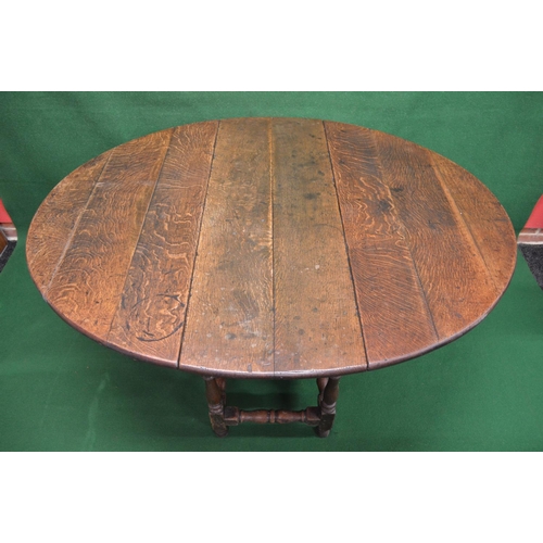 12 - Oak oval gateleg table the top having bow ends over single drawer with brass handle supported on blo... 