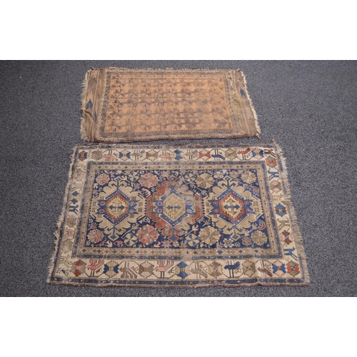 23 - Blue ground rug having cream, red and blue pattern with end tassels - 1.42m x 1.02m together with on... 