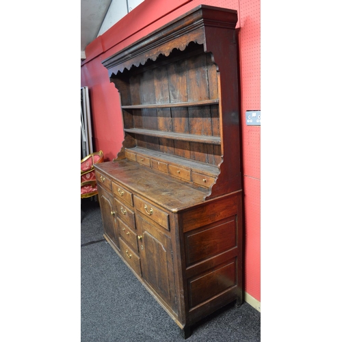 32 - Oak dresser having canopy three shelf top, the lower shelf over row of five short drawers, having wi... 