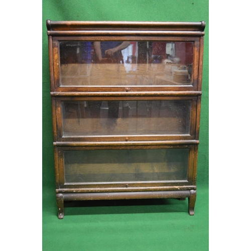 4 - Oak three section Globe Wernicke bookcase, each section having glazed up and over door and side meta... 