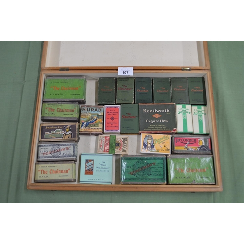 107 - Box containing twenty three vintage cigarette boxes/packets to include: The Chairman, Wild Woodbine ... 