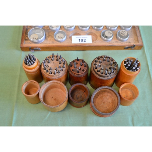 192 - Five treen containers containing watchmakers tools together with wooden case watch part containers