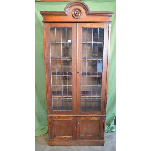 343 - Oak glazed two door bookcase with arched top - 35.75