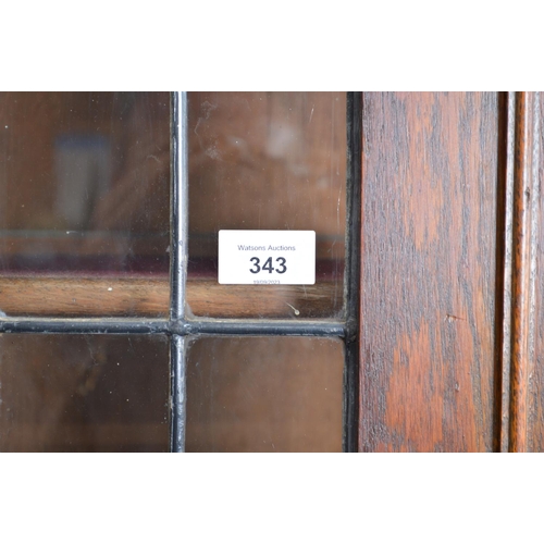 343 - Oak glazed two door bookcase with arched top - 35.75