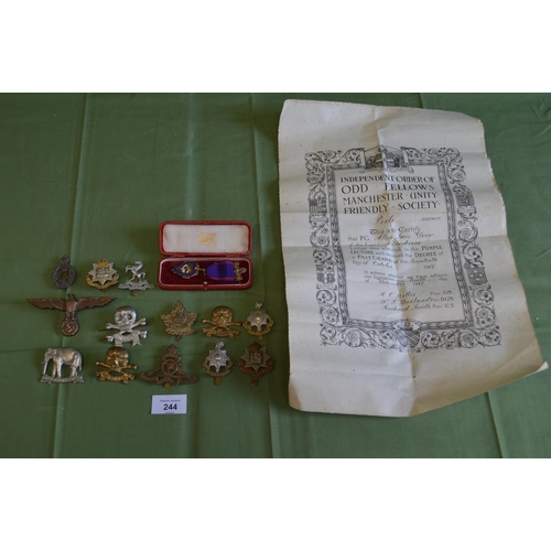 244 - Group of thirteen military cap badges together with cased silver gilt Odd Fellows jewel and certific... 