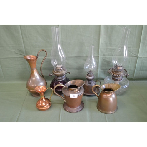 65 - Group of four copper and brass ewers and jugs together with three lamps