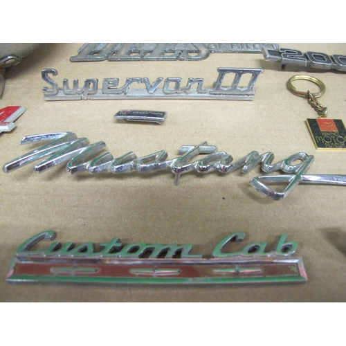 20 - Box of vehicle marque badges to include: Mustang, Supervan III, Custom Cab, Viva, Futura, Dees Of Bi... 