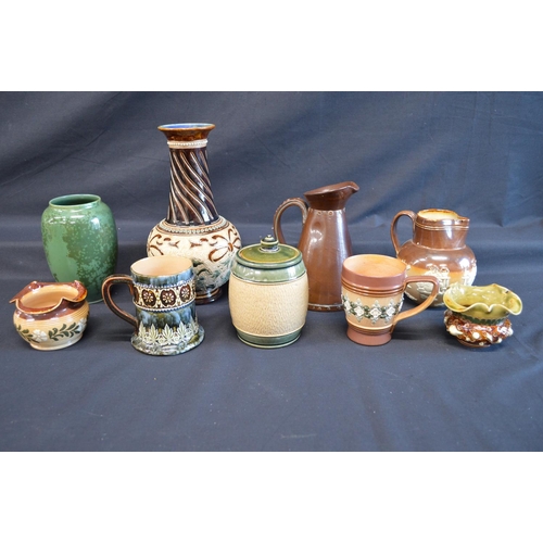 137 - Group of nine pieces of Royal Doulton Lambeth pottery to include: two vases, leather formed jug, Har... 