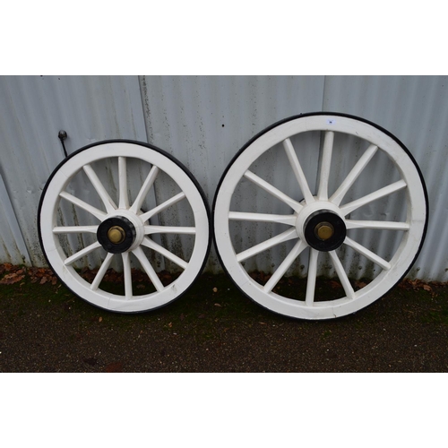 36 - Two painted wooden cart wheels with iron rims and brass hub nuts - 31.5