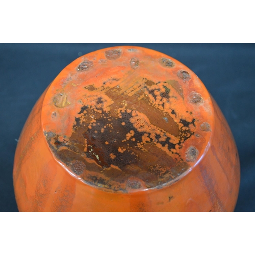 68 - Art pottery bulbous two handled vase in orange glaze with sun burst style decoration - 7.75