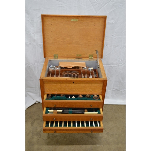 11 - Oak free standing cabinet containing a quantity of silver plated and stainless steel cutlery