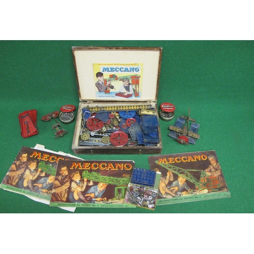 23 - Old wooden box of playworn blue, red and gold coloured Meccano with instructions for Outfits 1, 3 an... 