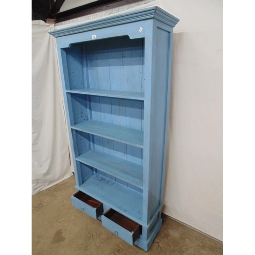 398 - Hardwood blue painted bookcase with three fixed shelves over two drawer base, standing on bracket fe... 
